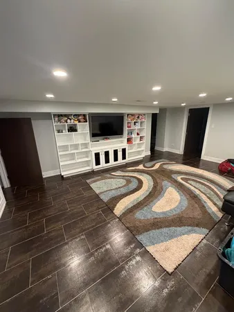 a large bedroom with a bed and a flat screen tv