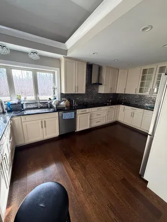 a kitchen with granite countertop a stove a sink and a microwave