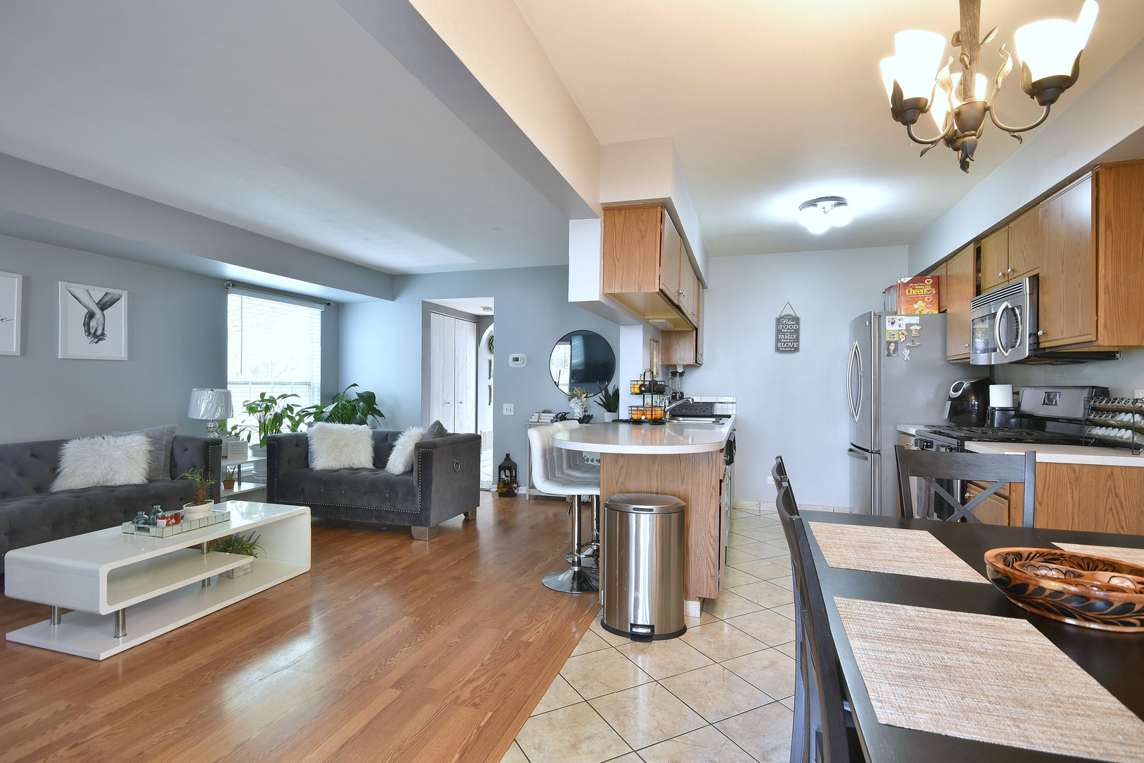 210 Shadybrook Lane Aurora, IL 60504 - Photo 15 of 26 a living room with furniture kitchen view and a wooden floor