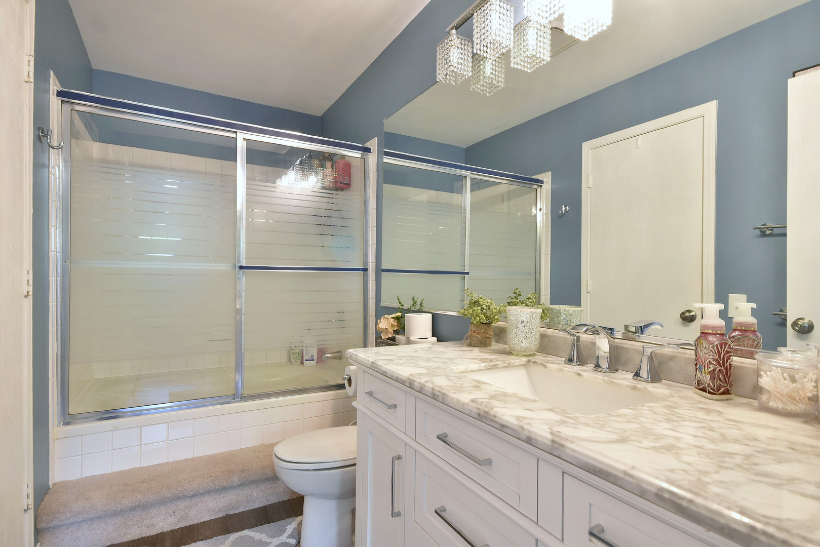 210 Shadybrook Lane Aurora, IL 60504 - Photo 19 of 26 a bathroom with a granite countertop sink a toilet a mirror and shower