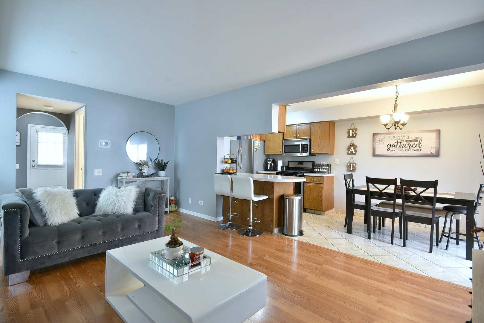 210 Shadybrook Lane Aurora, IL 60504 - Photo 5 of 26 a living room with furniture and a dining table with wooden floor