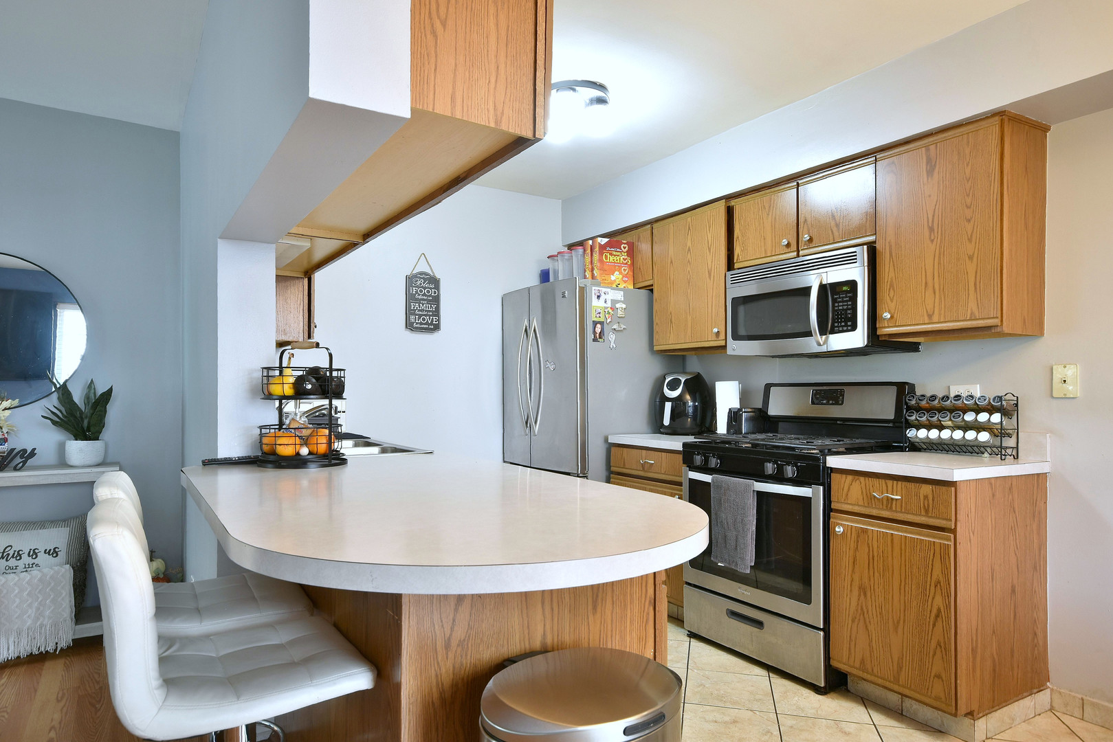 210 Shadybrook Lane Aurora, IL 60504 - Photo 7 of 26 a kitchen with stainless steel appliances a kitchen island a stove a table and chairs