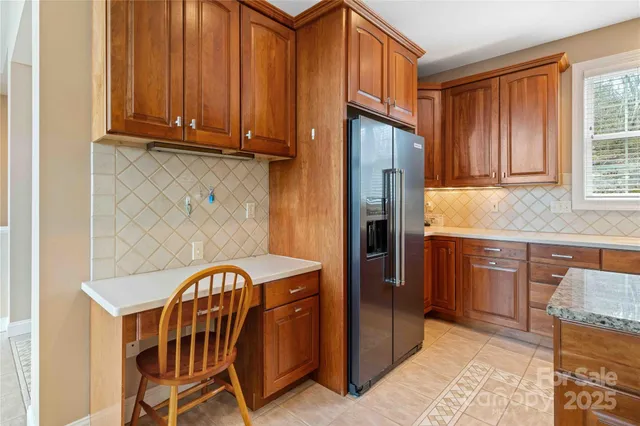 a kitchen with stainless steel appliances granite countertop a refrigerator and a sink