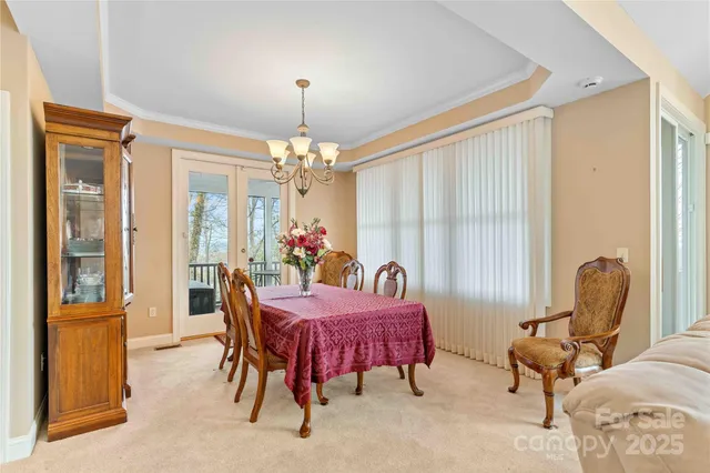 a dining room with furniture and chandelier
