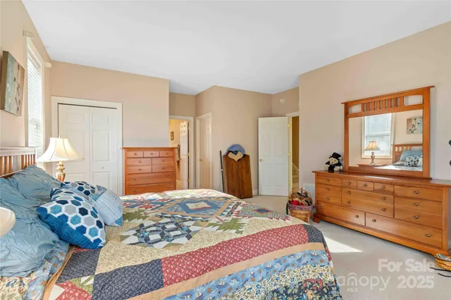 a bed room with a bed and a double vanity sink