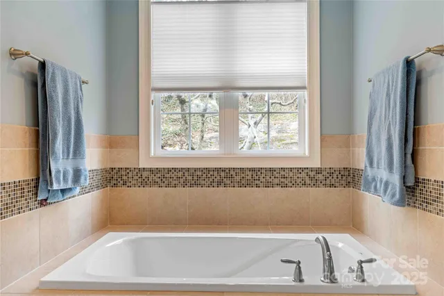 a bathroom with a bathtub and a window