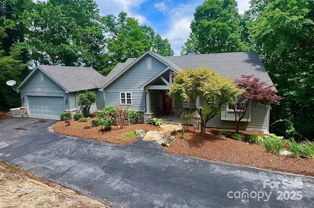 a view of a house with yard and sitting area