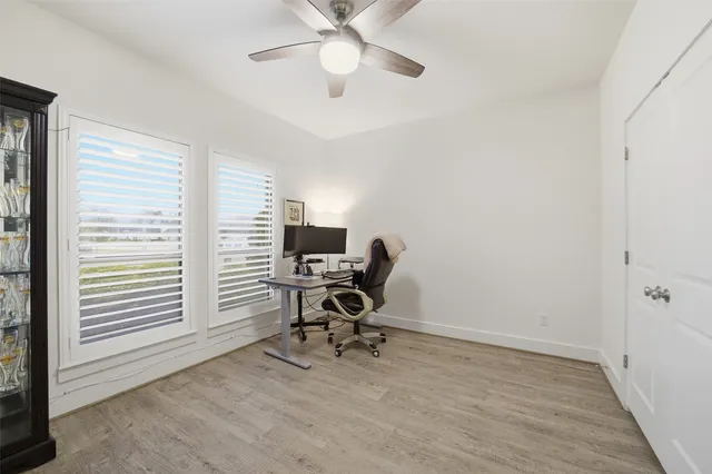 a view of an empty room with a window and a flat screen tv