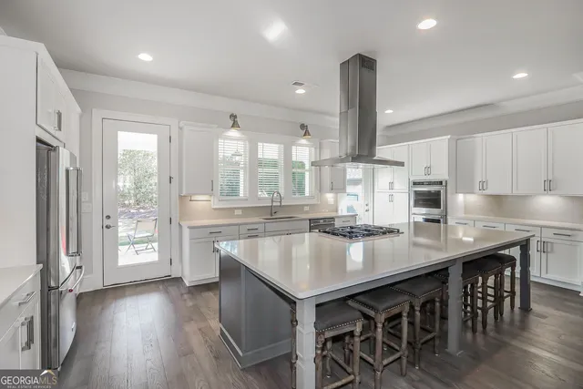 a kitchen with center island and stainless steel appliances