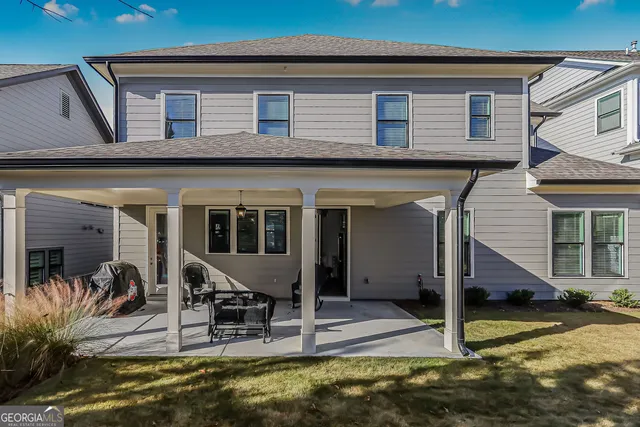 a view of a house with swimming pool next to a yard
