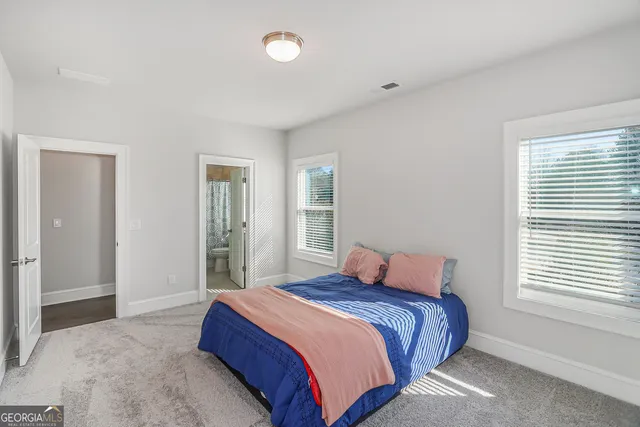 a bedroom with a large bed and a window