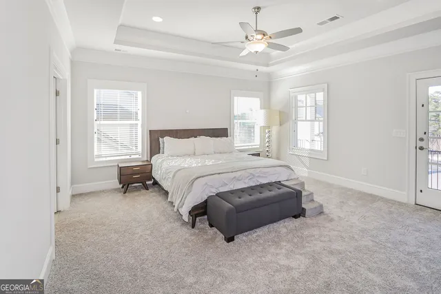 a spacious bedroom with a bed and a window