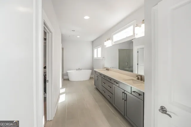 a spacious bathroom with a granite countertop sink mirror and a toilet