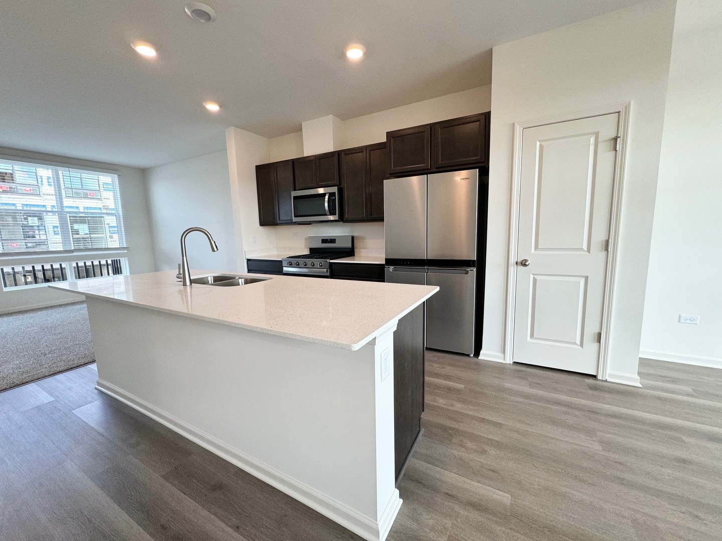 369 Summit Circle Lombard, IL 60148 - Photo 3 of 45 a kitchen with kitchen island a sink stainless steel appliances and cabinets