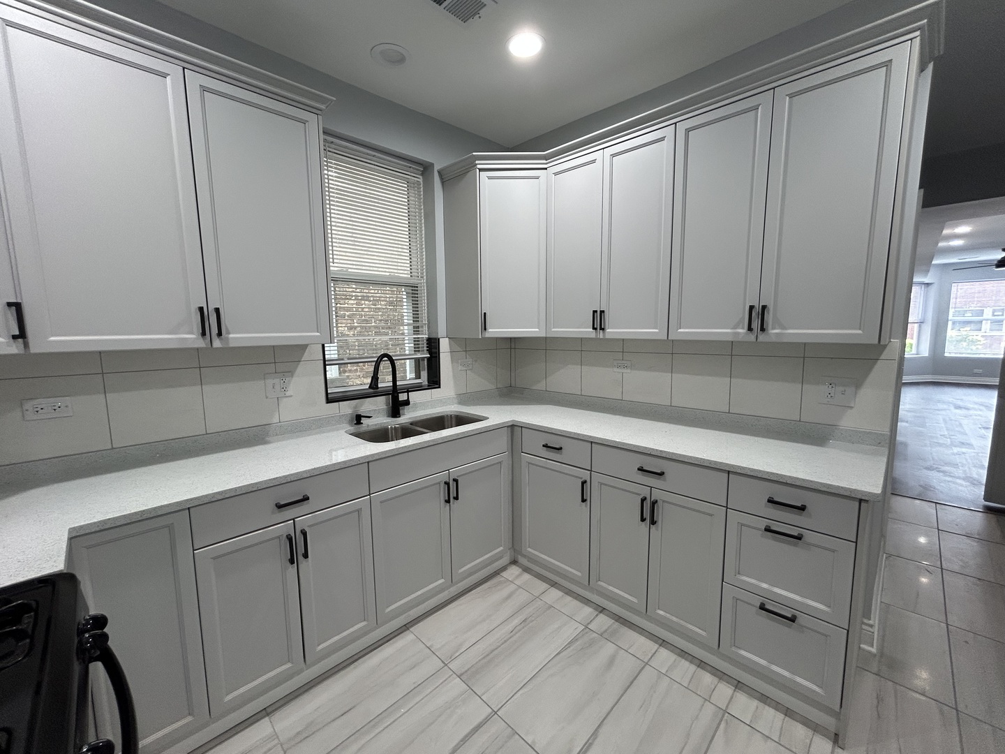7940 South Carpenter Street, Unit 2 Chicago, IL 60620 - Photo 22 of 34 a kitchen with white cabinets and sink