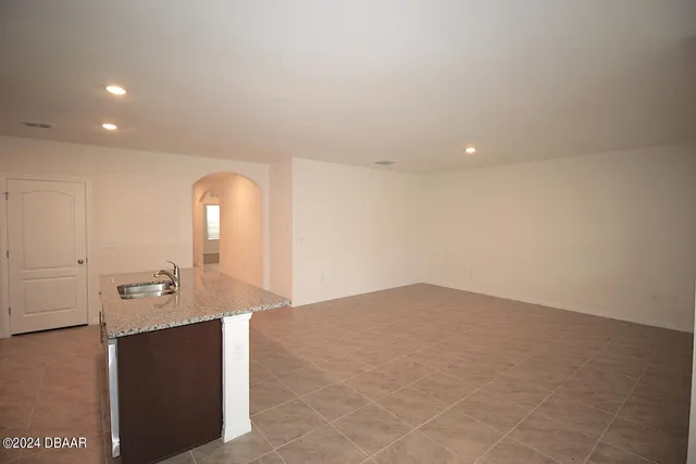 a kitchen with stainless steel appliances a refrigerator and a stove top oven
