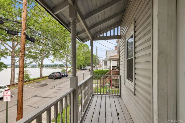 a view of balcony with wooden floor and fence