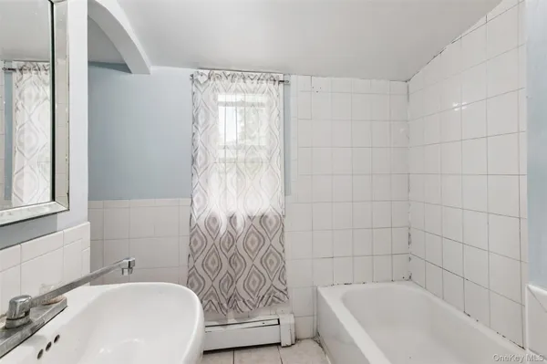 a bathroom with a bathtub and shower