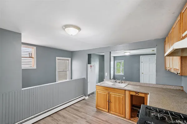 a spacious bathroom with a granite countertop sink mirror and a toilet