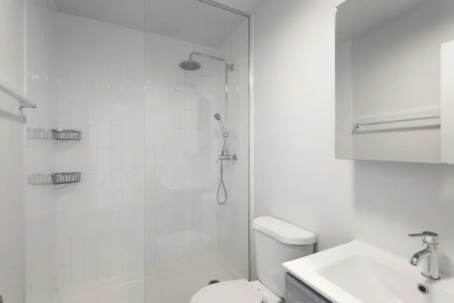 a bathroom with a sink toilet and shower