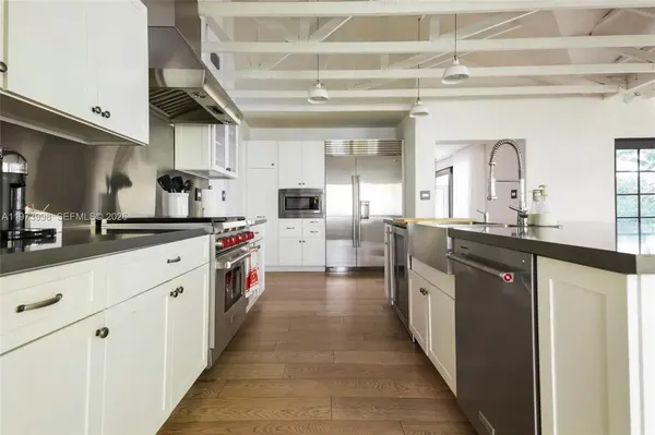 a kitchen with stainless steel appliances a sink and a refrigerator