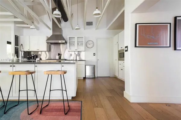 a kitchen with stainless steel appliances kitchen island a chandelier