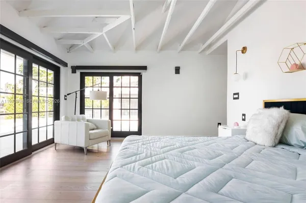 a bedroom with a large bed and a large window