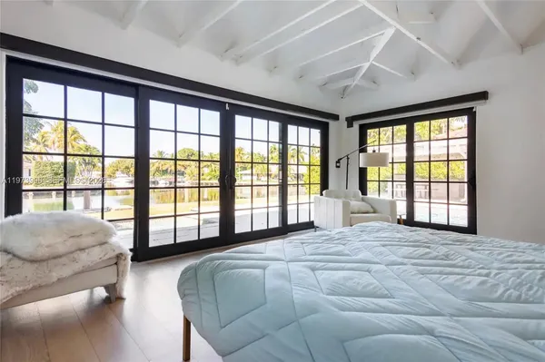 a spacious bedroom with a large bed and a large window