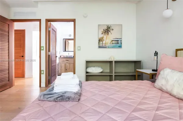 a bedroom with a large bed and a chandelier