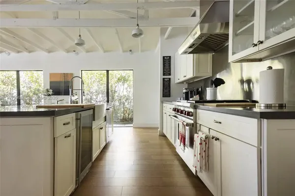 a kitchen with stainless steel appliances a sink and counter