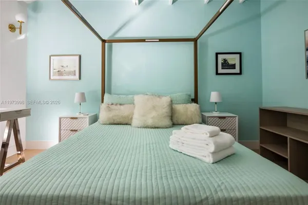 a bedroom with a bed and a lamp