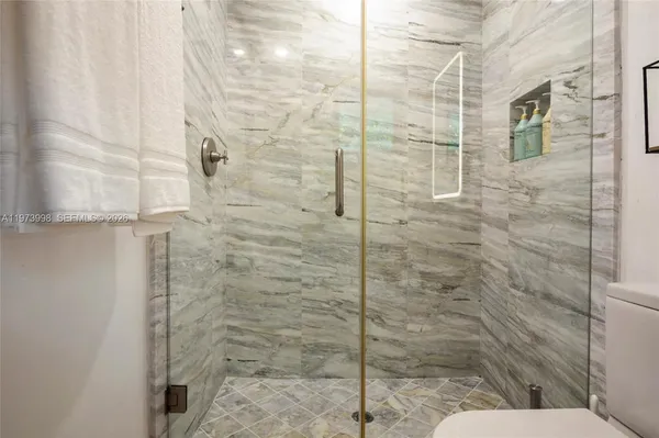 a bathroom with a toilet and shower