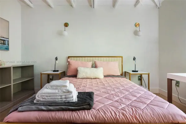 a bedroom with a large bed and a window