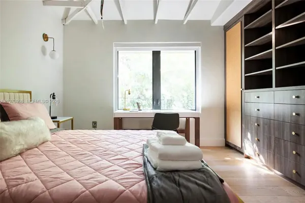 a bedroom with a bed and a window