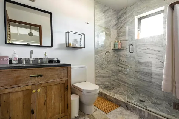 a bathroom with a toilet sink and a mirror