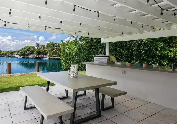a view of a patio with table and chairs and potted plants