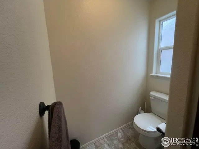 a white toilet sitting next to a shower