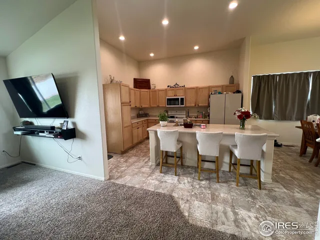 a kitchen with sink refrigerator and microwave