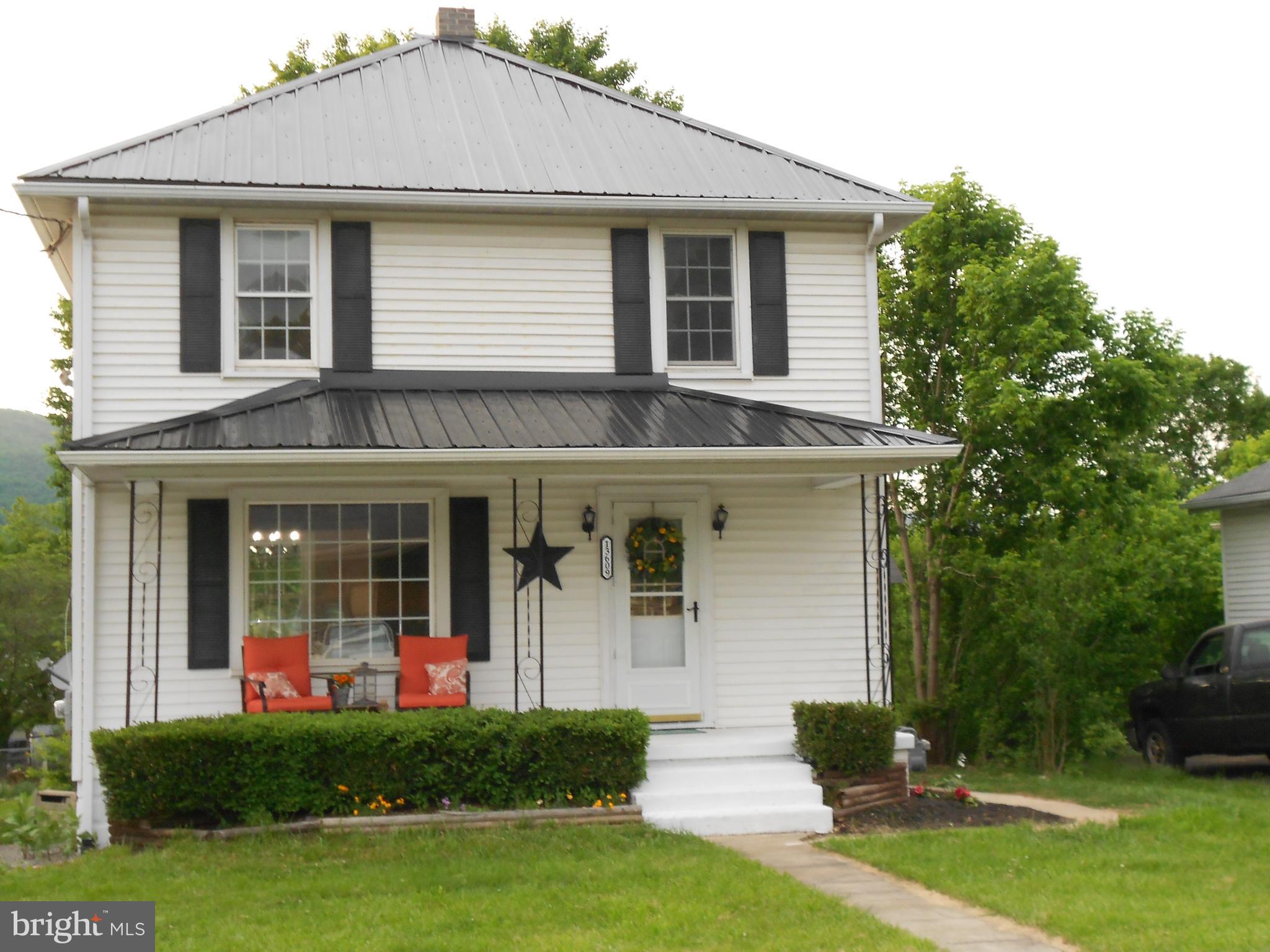 13609 Brant Road Southwest Cresaptown, MD 21502 - Photo 2 of 23 a front view of a house with a yard and porch