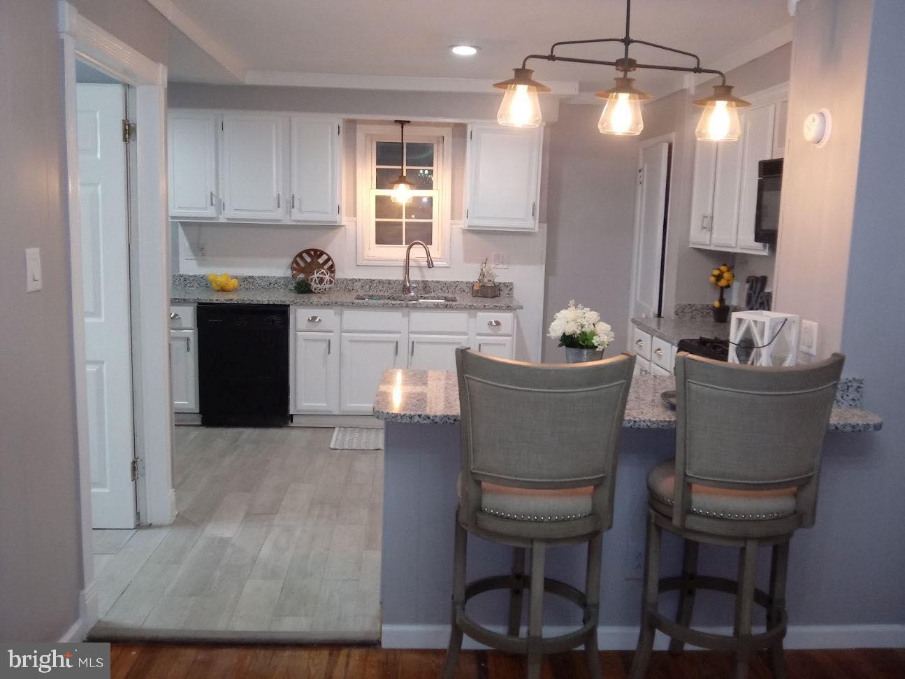 13609 Brant Road Southwest Cresaptown, MD 21502 - Photo 3 of 23 a kitchen with a table chairs sink and cabinets