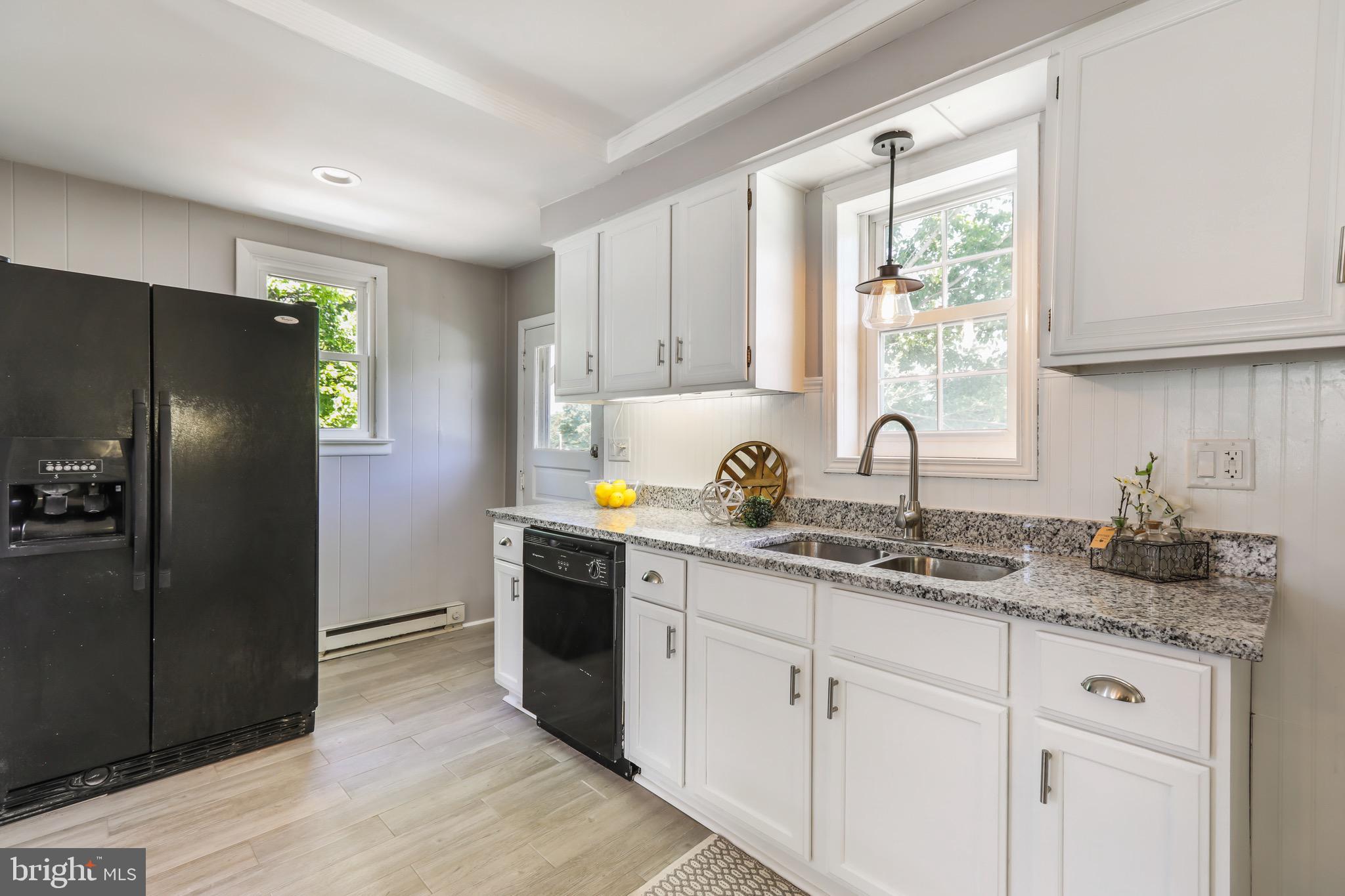 13609 Brant Road Southwest Cresaptown, MD 21502 - Photo 6 of 23 a kitchen with a sink and refrigerator