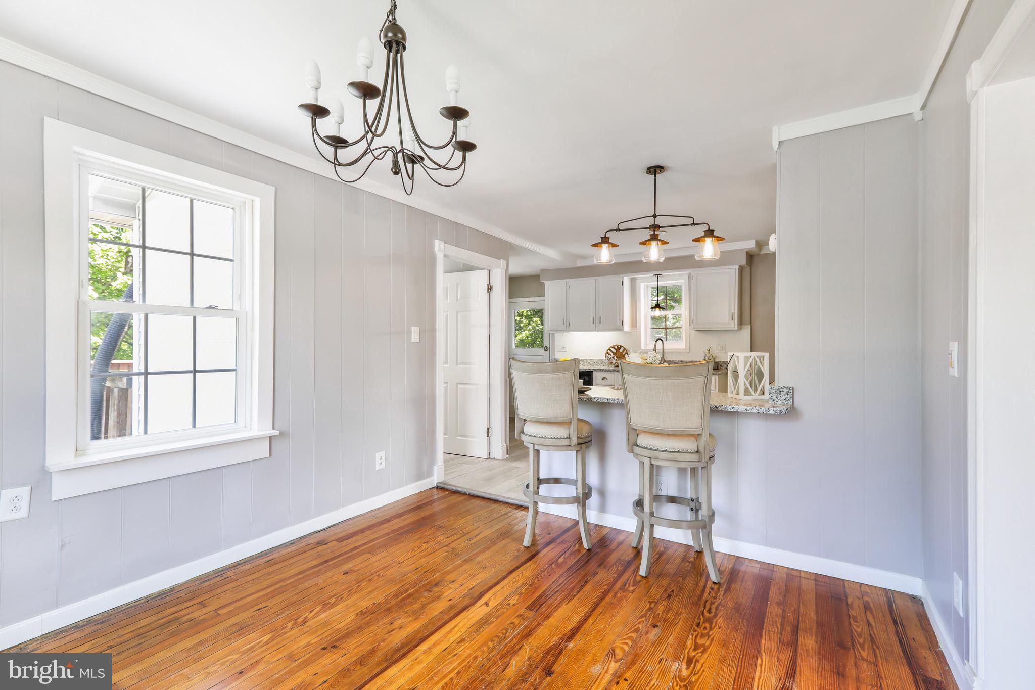 13609 Brant Road Southwest Cresaptown, MD 21502 - Photo 7 of 23 a view of a dining room with furniture wooden floor and chandelier