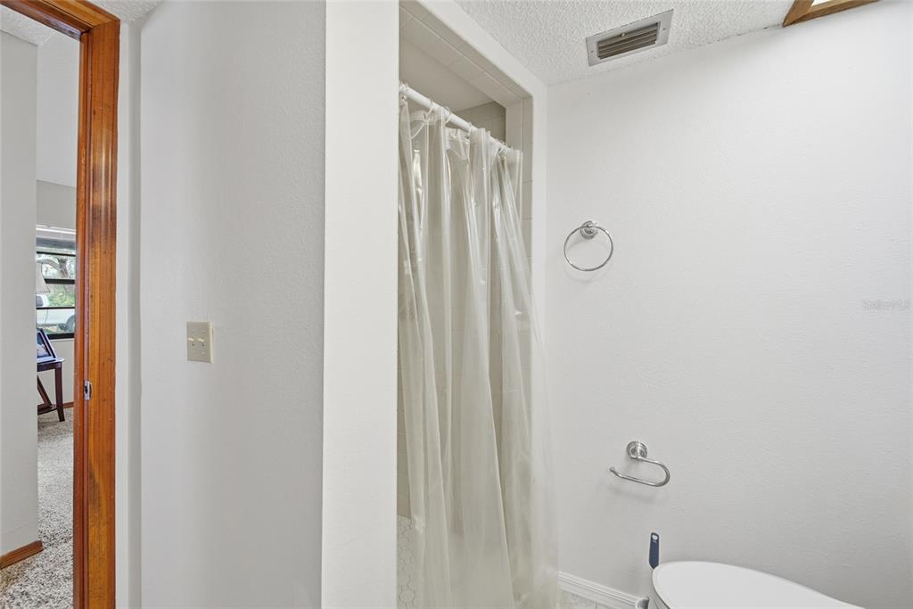 8398 Begonia Street Spring Hill, FL 34608 - Photo 18 of 32 a bathroom with a shower curtain