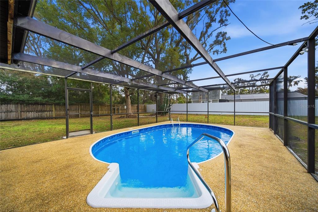 8398 Begonia Street Spring Hill, FL 34608 - Photo 20 of 32 a swimming pool with a yard