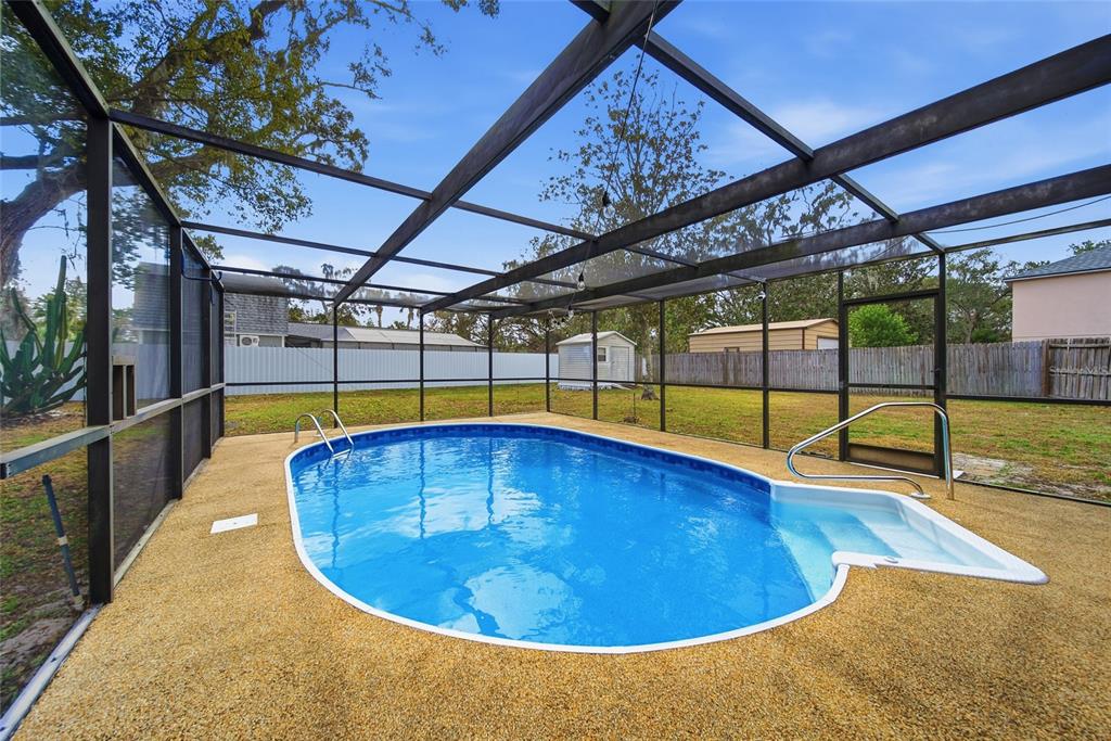 8398 Begonia Street Spring Hill, FL 34608 - Photo 21 of 32 a view of a swimming pools under an umbrella