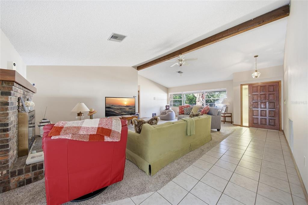 8398 Begonia Street Spring Hill, FL 34608 - Photo 3 of 32 a living room with furniture and a flat screen tv