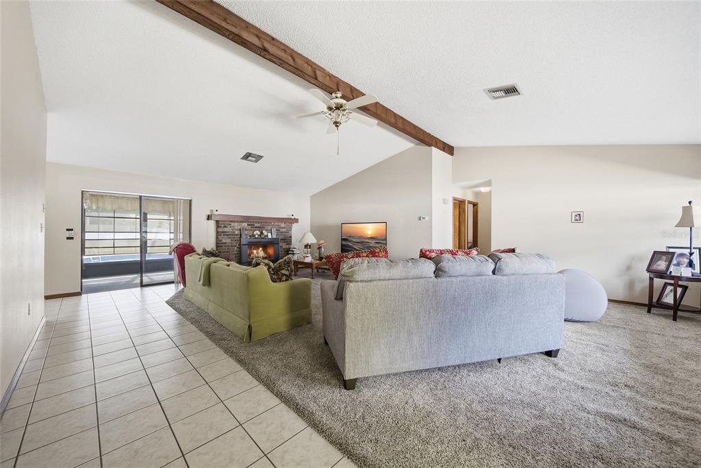 8398 Begonia Street Spring Hill, FL 34608 - Photo 4 of 32 a living room with furniture and a flat screen tv