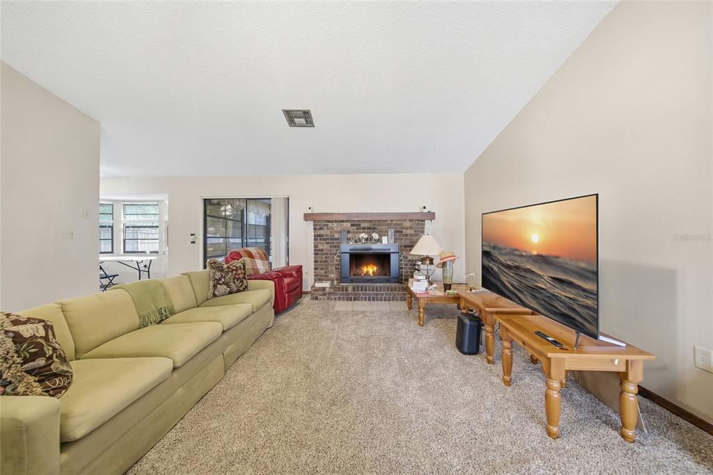 8398 Begonia Street Spring Hill, FL 34608 - Photo 6 of 32 a living room with furniture and a flat screen tv