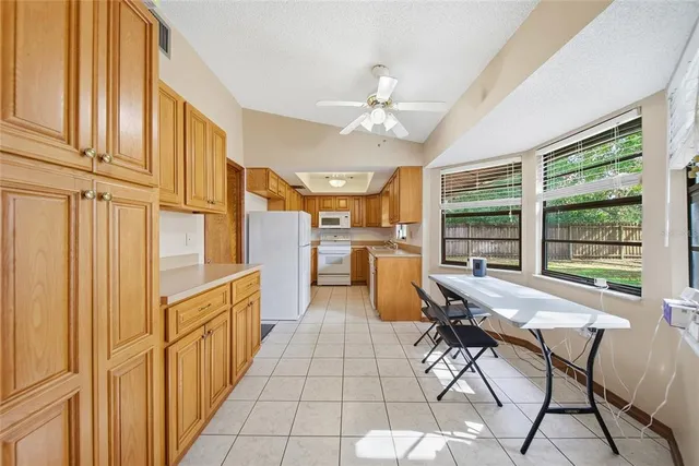 a open kitchen with stainless steel appliances granite countertop a refrigerator and microwave