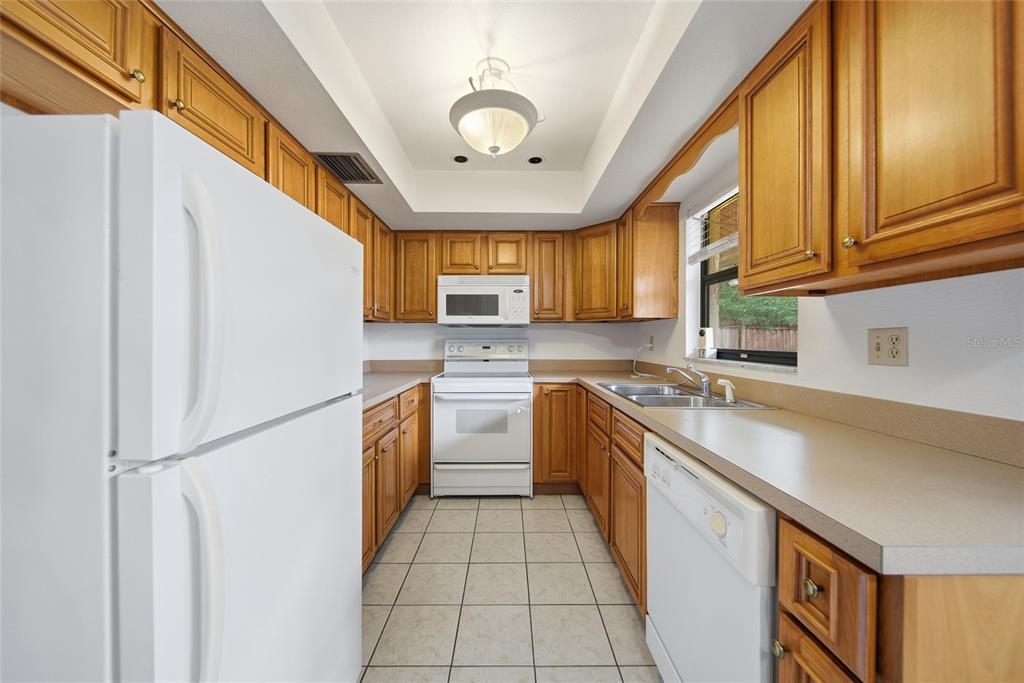 8398 Begonia Street Spring Hill, FL 34608 - Photo 8 of 32 a kitchen with a sink a stove top oven and cabinetry